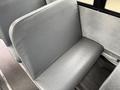 A gray vinyl seat inside a bus with a simple, clean design and no visible markings on the surface