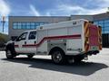 A 2009 Ford F-550 emergency response vehicle with a white body and red stripes designed for utility and service purposes
