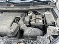 A 2016 Ford Explorer engine compartment showing the air intake, battery, and other components covered in dust and dirt
