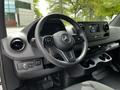 Interior view of a 2023 Mercedes-Benz Sprinter showing the steering wheel dashboard and control panel