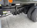 A 2017 Ford F-750 truck chassis showing the suspension and dual rear tires with visible warning labels on the frame