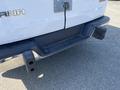 A 2016 GMC Savana with a visible rear bumper and hitch receiver