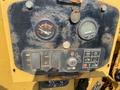 Control panel of a 2010 Vermeer Corporation BC1200XL featuring fuel gauge ignition switch and various operational buttons