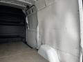 Interior view of a 2021 Mercedes-Benz Sprinter van showcasing the cargo area with a flat floor and panel walls