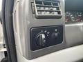 Dashboard controls of a 2003 Ford F-450 SD showing the headlight switch and air vent with gauges visible in the background