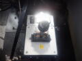 A close-up view of the gear shift lever for a 2016 International WorkStar 7500 featuring a metallic plate and control buttons