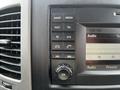 Dashboard controls of a 2017 Mercedes-Benz Sprinter featuring buttons for radio media navigation and a display screen showing audio settings