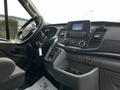 Interior view of a 2020 Ford Transit showcasing the steering wheel dashboard and control panel with touchscreen display and gear shift