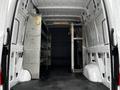 Interior view of a 2020 Mercedes-Benz Sprinter showing metal shelving units along the sides of the cargo space with a flat rubber floor and ample headroom