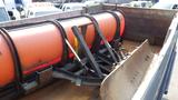 A 2003 International 5600i truck with an orange snow plow attachment and a metal loading area showing signs of wear and rust