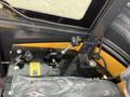 Close-up of the control panel of a 2024 AGT Industrial Yellow H13R Mini Excavator showcasing levers gauges and switches