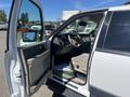 A 2013 Ford Expedition with its driver's side door open, showcasing the dashboard and interior seating in beige tones