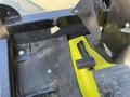 Close-up of the control panel of a 2010 Kubota F3990 featuring a black handle lever and various textured surfaces with visible screws and a label