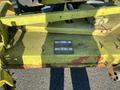 A worn yellow mower deck from a 2010 Kubota F3680 with visible wear and safety warning labels attached to the surface