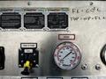 A close-up of the control panel of a 2006 Emergency One Fire Truck featuring gauges, switches, and operating instructions