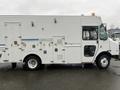A 2012 Workhorse W62 vehicle with a white exterior featuring multiple side compartments and a large cargo area