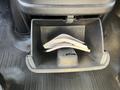 A black plastic glove compartment with paperwork inside in a 2016 GMC Savana