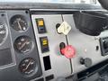 Interior dashboard of a 1998 Freightliner FL80 featuring gauges for fuel air pressure and parking brake controls