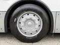 Close-up of a gray bus wheel with a circular hubcap featuring the word "Brist" and a black tire with visible tread patterns