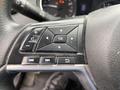 Close-up of the steering wheel controls of a 2019 Nissan Rogue featuring buttons for audio and navigation functions