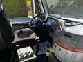 Interior view of a 2005 Volvo VND 122 showing the driver's seat gear shift and dashboard controls