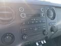 Interior dashboard of a 2015 Ford F-450 SD featuring a sound system climate controls and various buttons and knobs