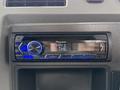 A Pioneer car stereo with a digital display and blue lighting mounted in the dashboard of a 2016 Peterbilt 348