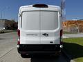 A white 2022 Ford Transit van viewed from the rear with a plain back and black bumper