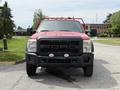Front view of a red 2013 Ford F-550 with a black grille and fog lights