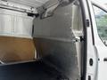 Interior of a 2014 Ford Transit Connect showing a metal divider and a rubberized floor mat