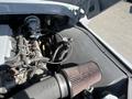 A 1962 Ford F-100 with its hood raised showcasing the engine compartment including an air filter and various engine components