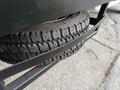 A 2020 Ford F-550 showing a close-up of its heavy-duty tires stacked on a black metal rack
