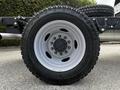 A close-up of a wheel from a 2024 Ford F-550 featuring a gray rim and a rugged tire tread