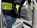 Interior view of a 2022 RAM 3500 showing the rear seats with black leather and fabric upholstery
