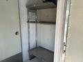 Interior shelving unit inside a 2019 Freightliner MT45 featuring two metal shelves and a narrow frame