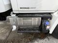 A 2017 Hino 338 truck showing the side step, fuel tank, and exhaust system details in silver and black