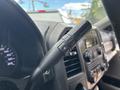 Close-up of a 2017 Ford F-550 steering column with a gear shift lever featuring a "+" and "−" button for gear selection