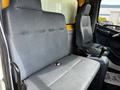 Two spacious gray vinyl seats in the cab of a 2006 Hino 268 with armrests and seat belts visible