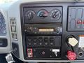 Dashboard of a 2013 International 7400 with gauges switches a radio and various control buttons