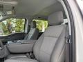 Interior of a 2024 Ford F-550 showing the front seats and center console with a grey fabric finish