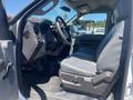 Interior view of a 2015 Ford F-450 SD showing the driver's side seat and dashboard with grey upholstery and controls