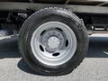 A close-up of a silver wheel and tire from a 2008 Ford F-550 showcasing the tread pattern and wheel design