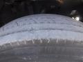 Close-up of a worn tire from a 2005 Freightliner M2 106 Medium Duty truck showing tread wear and grooves on the surface