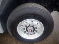 A close-up view of a Goodyear tire mounted on a silver wheel with multiple lug nuts on a 2008 International 7400 vehicle