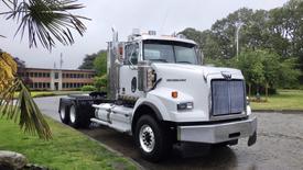 A 2019 Western Star Trucks 4900 SA in white with chrome accents featuring a large front grille and a high cab design