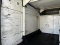 Interior of a 2008 Ford F-550 cargo space featuring worn walls and a black floor with metal fittings