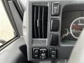 Control panel of a 2018 Isuzu NRR featuring air conditioning vents and various switches for vehicle functions