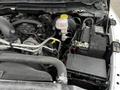 Close-up view of the engine compartment of a 2022 RAM 1500 Classic showing the engine components battery and fluid reservoir