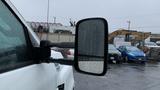 A 2021 International CV515 truck with a close-up view of its side mirror reflecting raindrops