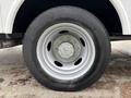 Close-up of a wheel from a 2018 Ford F-550 featuring a silver alloy rim and a black tire with tread patterns designed for heavy-duty performance